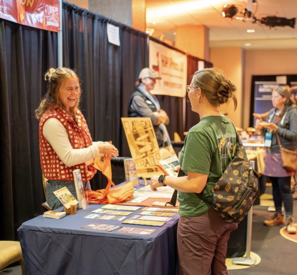 Person interacting at a vendor booth.